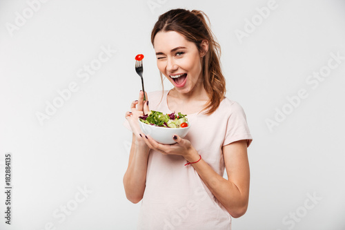 Fotografía Portrait of a happy playful girl eating fresh salad