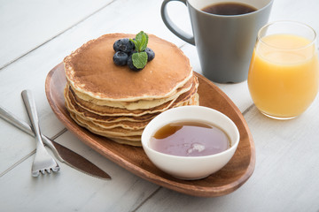 Wall Mural - isolated blue berry pancake with  syrup and drink