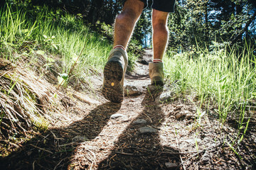 Hiking man in the forest and close up hiking boots