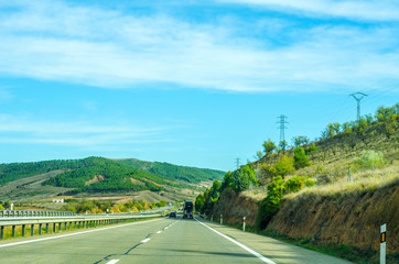 Fast road in the mountains in Spain, beautiful landscape of mountains, dry earth and rock from the sun