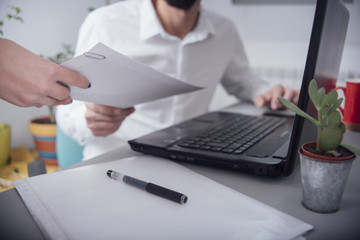 Man in the office  giving paper