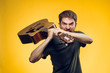© SHOTPRIME STUDIO - 2043701 A musician with a beard holds a guitar on a yellow background