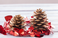 Close Up Gold Pine Cones And Christmas Decoration On A White Wooden Table Background.