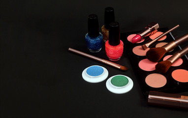 Set of decorative cosmetics on black background