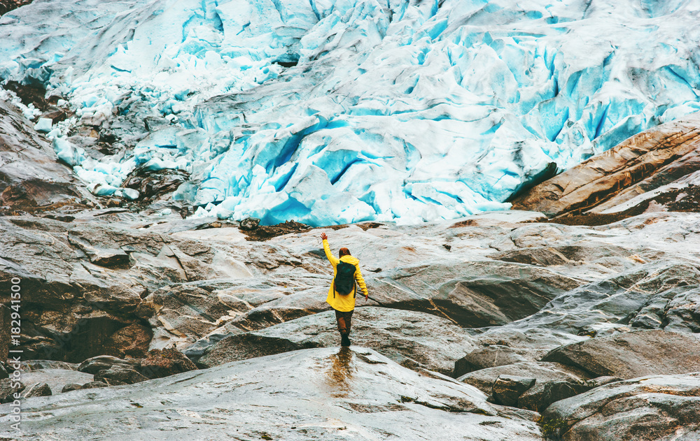 Woman hiking at Nigardsbreen glacier  Travel Lifestyle ecology concept adventure vacations outdoor nature in Norway - obrazy, fototapety, plakaty 