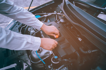 Car Engine oil maintenance repair automotive worker.Focusing soft orange image