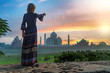 Beautiful girl points to Taj Mahal. Travel concept