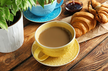 Wall Mural - Ceramic cup with delicious coffee on wooden table