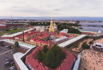 Wall Mural - Beautiful aerial morning view of Saint-Petersburg, Russia, The Vasilievskiy Island at sunrise, Isaacs Cathedral, Admiralty, Palace Bridge, cityscape and scenery beyond the city, shot from drone