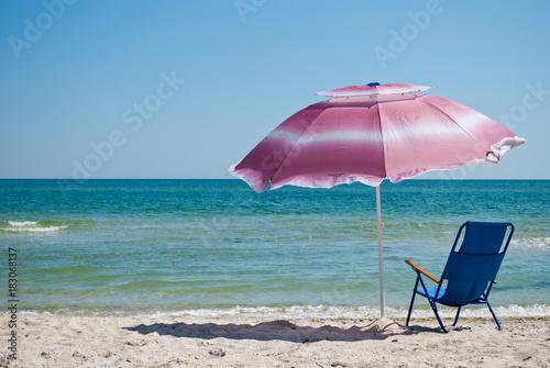 Blue Beach Chair And Pink Big Outdoor Umbrella For Shade On