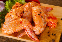 Raw marinated chicken wings