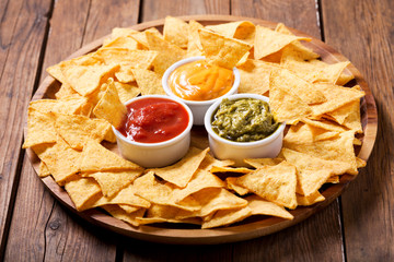 mexican nachos corn chips with guacamole, salsa and cheese dip