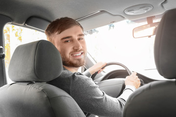 Wall Mural - Handsome young man driving taxi car