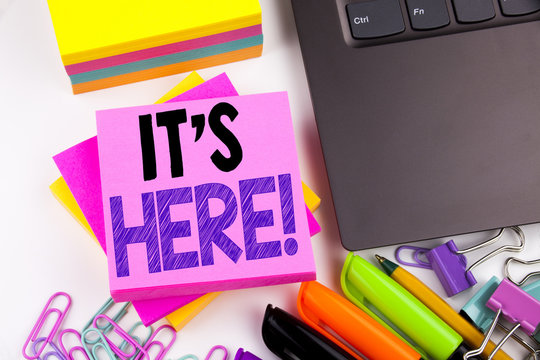Writing text showing It's Here made in the office with surroundings such as laptop, marker, pen. Business concept for advertisement Workshop white background copy space