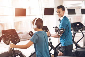 Wall Mural - Dad and son in the same clothes in gym. Father and son lead a healthy lifestyle.