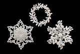 Fototapeta  - Christmas and New Year decorations: figurines of a snowflake. Isolated, black background.