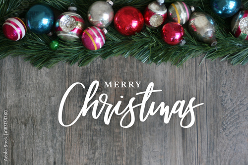 Fotografie, Obraz Merry Christmas Calligraphy with Festive Colorful Holiday Christmas Ornament Bor