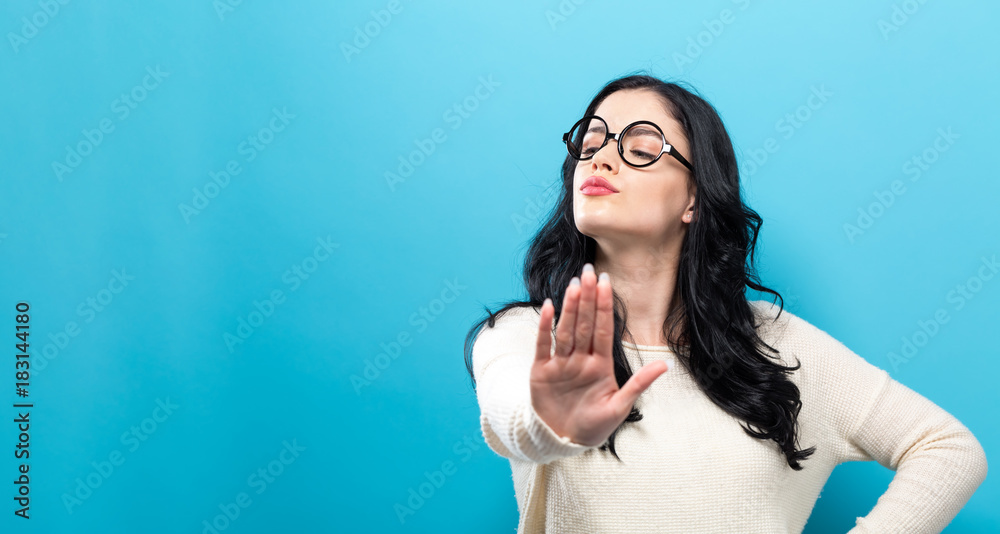 Young woman making a rejection pose a solid background - obrazy, fototapety, plakaty 