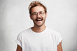© wayhome.studio  - Portrait of glad attractive man with trendy hairdo, beard and mustache, laughs happily at funny story or joke, being in good mood, expresses positive emotions. Satisfied male student finishes work