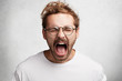 © wayhome.studio - Headshot of emotional crazy male yells loudly, being irritated with someone or something, expresses negative emotions, isolated over white background. Mad stylish man shouts or screams at friend