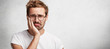 Discontent sorrorful male has terrible toothache, can`t stand pain, being upset, poses against white background with copy space for your advertising content. Upset unhappy man has some troubles