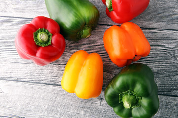 Wall Mural - Red, green and yellow sweet bell peppers on table.