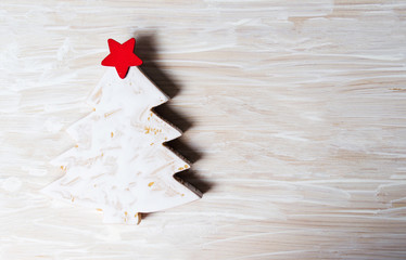 Wall Mural - Christmas tree miniature on a wooden background