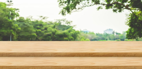 Aufkleber - Empty step wood table top food stand with blur green park tree background bokeh light,Mock up for display or montage of product,Banner for advertise on online media,nature business presentation
