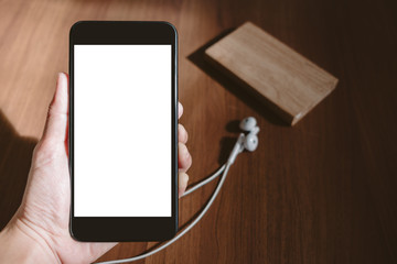 Poster - Hand holding mobile phone with white blank screen oat blur wood table,Mock up for display of content or design,Digital marketing strategy,clipping path.