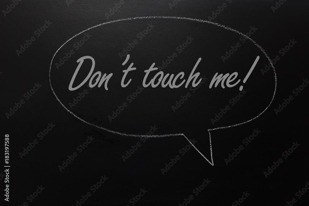 Sexual harassment concept. TEXT: Don't touch me written on blackboard