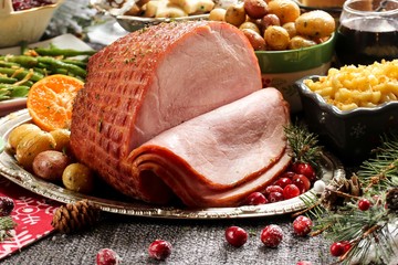 holiday baked ham with sides / xmas dinner table setting, selective focus