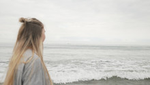 Teen Girl Walking On Santa Monica Beach In Cloudy November Day Motion Blur