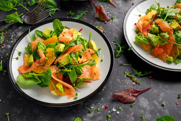 Wall Mural - Fresh salmon salad with avocado, orange and green vegetables.