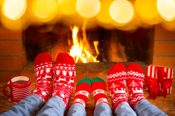 Poster - Family in Christmas socks near fireplace