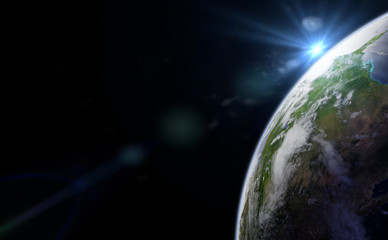Wall Mural - the bright sun appears over the horizon of planet earth