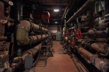 Old vintage control center in the boiler room with tubes and round water taps