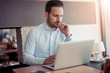 © ivanko80 - Young man working with laptop in office.