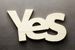 Wood word yes on a grey background