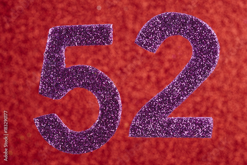 Fotografia Number fifty-two purple over a red background. Anniversary.