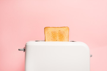 Healthy fashion food of breakfast. Toast in a toaster on a pink background.