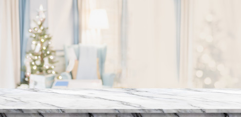 Fototapete - Empty white marble table top with abstract warm living room decor with christmas tree blur background with bokeh light,Holiday backdrop,Mock up banner for display of advertise product ,luxury house.