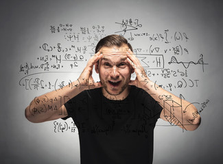 Shocked man looking at mathematical equation.