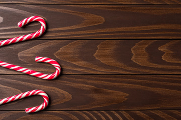 Wall Mural - Candy canes on wooden background