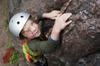 © Scandinav - Boy climbing on rock