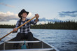 © Scandinav - Woman canoeing on lake