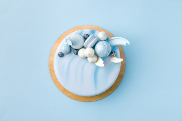 Wall Mural - top view of blue tasty cake isolated on blue