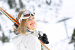 Happy skier girl ready to ski in a slope