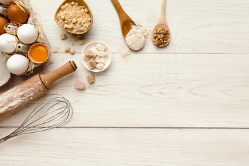 Wall Mural - Baking background with eggs and flour on white rustic wood