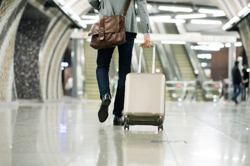 Wall Mural - Businessman in front of escalators on a metro station.