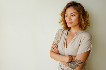 Portrait of worried young woman standing in studio